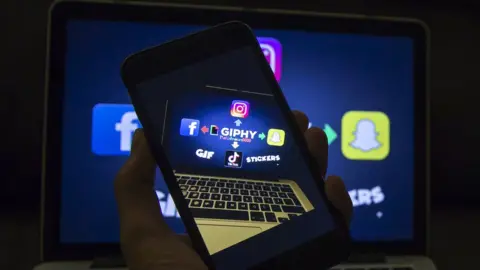 Getty Images A photo illustration shows the giphy logo with arrows pointing out to the logos of Facebook, Instagram, TikTok, and Snapchat