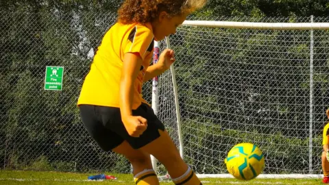 Alice Mann/Team GB Dora McHardy kicks a football into a goal