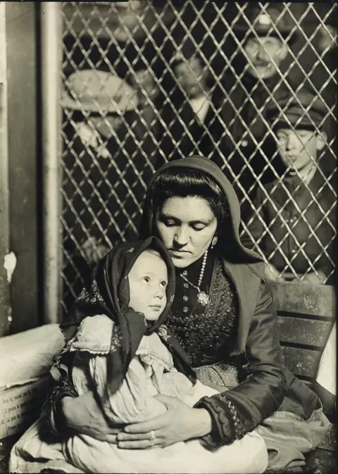 Courtesy of Swann Auction Galleries A mother holds her child in her lap.