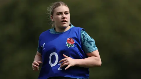 England Women's rugby international Mackenzie Carson wearing a blue bib while taking part in a training session with her country.