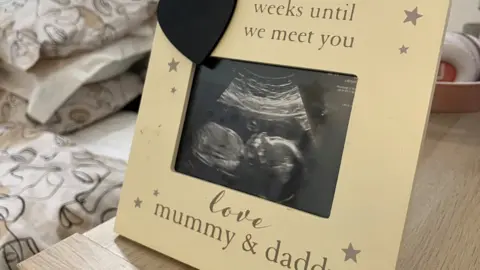 Jamie Coulson/BBC Image of baby scan in a frame