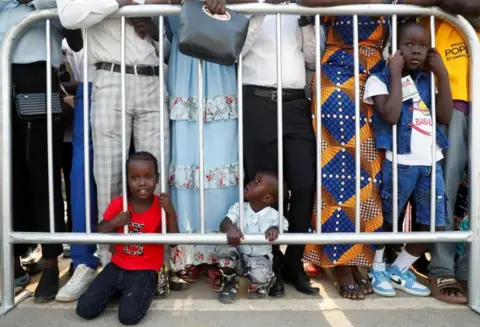 Reuters Children wait for the arrival of the Pope