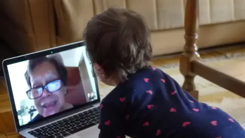 Getty Images Toddler speaks to grandmother on zoom