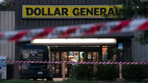 Getty Images A biohazard cleanup vehicle is parked outside the Dollar General store where three people were shot and killed the day before
