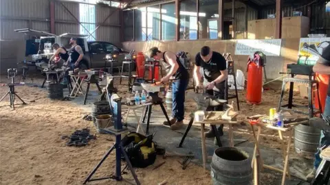Michael Bellamy and other farriers hammering horse shoes