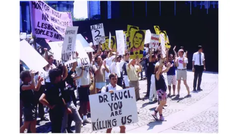 J Clin Invest. 2007 Aids activist holds a sign reading: "Dr Fauci you are killing us"