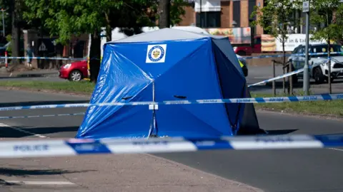 PA Media A police tent at the scene on College Road, Kingstanding, north of Birmingham,