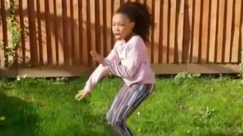 Eisteddfod T Girl dancing in a garden