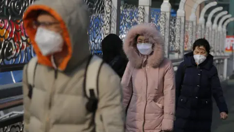 EPA People wearing masks in Beijing