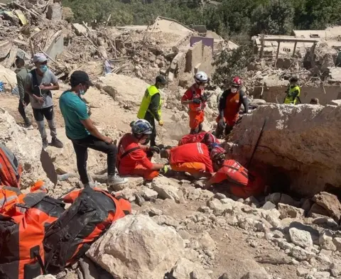 UK International Search and Rescue The UK International Search and Rescue team search for survivors trapped under collapsed buildings in the mountains of Asni, in Morocco