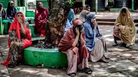 Getty Images Yassin Hussein Moyos relatives cry prior to Yassins burial at Kariokor Muslim Cemetery in Nairobi, Kenya on March 31, 2020.