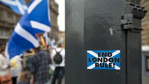 Getty Images A sticker proclaiming 'End London Rule' in Edinburgh, September 2014