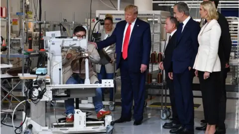 Getty Images Donald Trump visits a US factory.