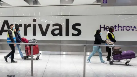 Getty Images people arrive into Heathrow