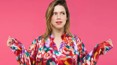 Megan Gisborne Lou Sanders in front of a pink background