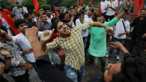 Reuters Activists from the Akhil Bharatiya Vidyarthi Parishad (ABVP), the student wing of India's ruling Bharatiya Janata Party (BJP), celebrate after the government scrapped the special status for Kashmir, in New Delhi, India, August 5, 2019.