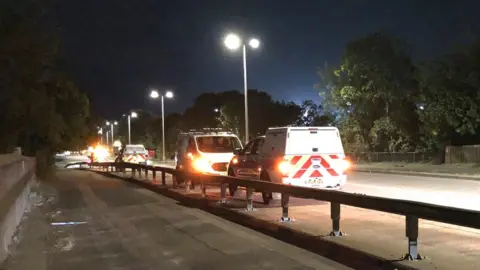 Kate Bradbrook/BBC Emergency services vehicles on a bridge over the railway line in Stevenage