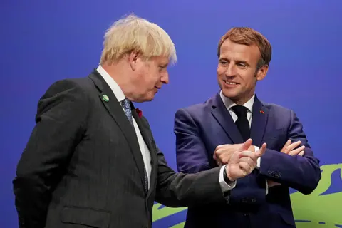 Reuters Prime Minister Boris Johnson greets France's President Emmanuel Macron during arrivals at the UN Climate Change Conference (COP26) in Glasgow, Scotland, on 1 November 2021