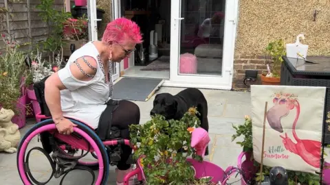 BBC Mel Humphreys inspects her garden with her very lovely dog.