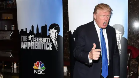 Getty Images President Donald Trump posing at a red carpet event for the launch of The Celebrity Apprentice TV series in 2015