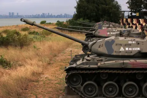 Getty Images As the city of Xiamen, China, is seen in the background, retired M41 “Walker Bulldog” light tanks, which had served the Taiwanese Army for 63 years, are on display by a beach on October 7, 2023 in Kinmen, Taiwan.