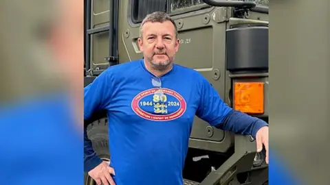 Dave Westall Dave standing in front of truck