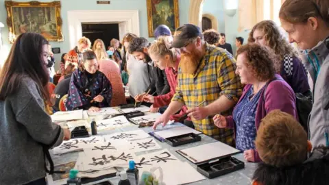 Yumiko Jones Image of people at a workshop at a Bristol Japanese Cultural Society event.