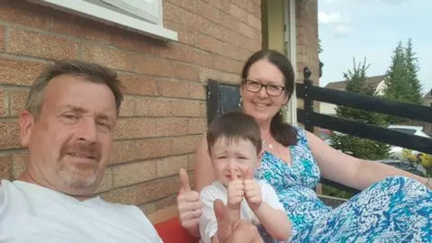 Wales News Service Colin Morton with his wife Tracey and son Jackson