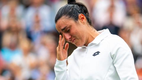 Ons Jabeur wipes away a tear during the trophy presentation at Wimbledon 2023