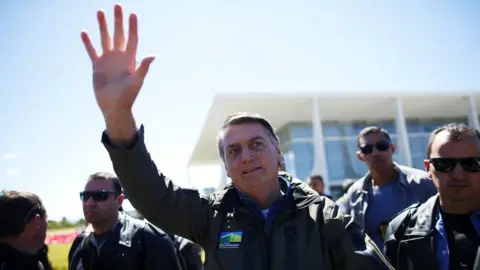 Reuters Brazil's President Jair Bolsonaro gestures to the crowd at a motorcade rally