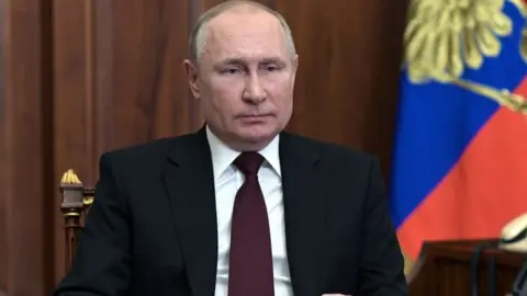 Getty Images Russian President Vladimir Putin speaks during his address to the nation at the Kremlin in Moscow on 21 February