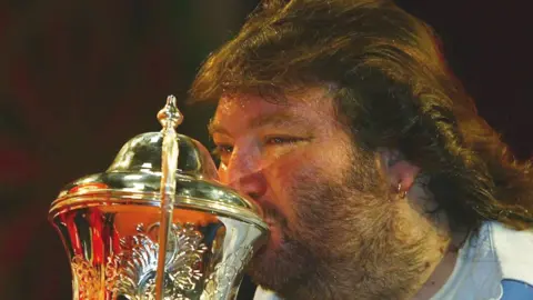 Getty Images Andy Fordham kisses the trophy after winning The BDO Lakeside World Darts Championships in January 2004