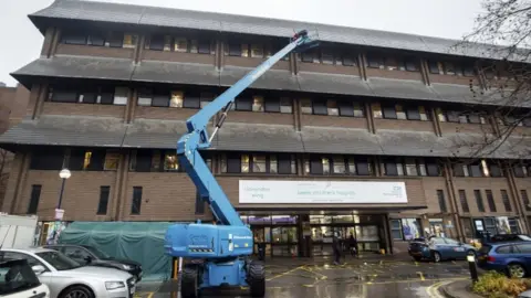 PA Media Santa Claus used the cherry picker to be able to reach all four levels of the hospital