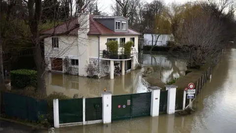 AFP A photo taken on 29 January 2018 shows a house surrounded by floodwater from the Seine river in Bougival, west of Paris