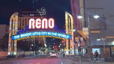 General view of Reno, with a sign describing it as "the biggest little city in the world"