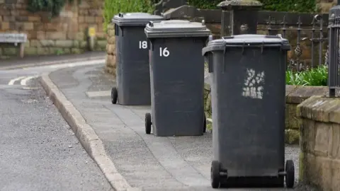 BBC Black bins on the pavement to be collected