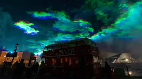 Mark McNulty mass of green lights above the double decker Diner bus on the waterfront