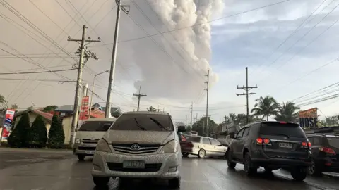 EPA An ash column from Taal volcano looms over Tagaytay city, Philippines, 12 January 2020.