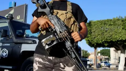 Reuters Man holding large gun in Tripoli, Libya