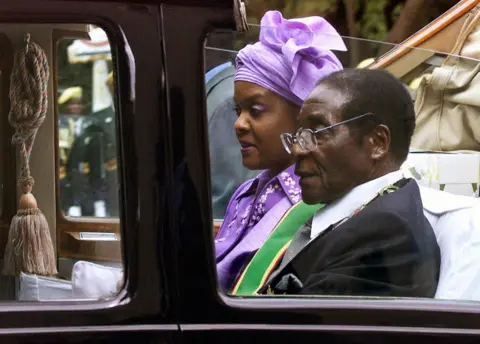 AFP President Robert Mugabe and his wife Grace leave parliament in their ceremonial car after its official opening, Harare - 22 July 2003