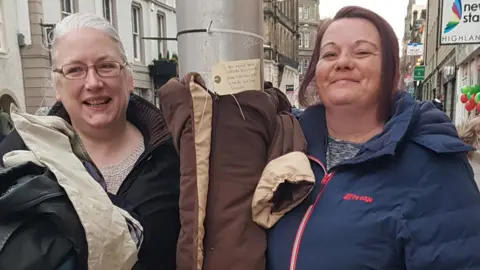 Serenity Serenity team with a jacket on a lamppost