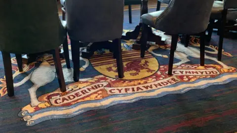 Wales news service The carpet with the coat of arms