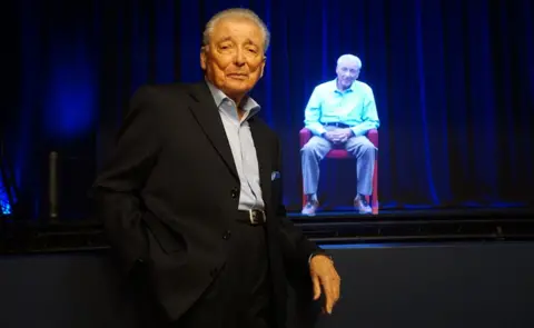 Ron Gould Studios A Holocaust survivor with his avatar at the Shoah Foundation