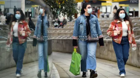 Getty Images People wearing masks in Manchester city centre