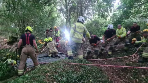 Cornwall Air Ambulance  Firefighters and paramedics at the mine shaft in St Blazey