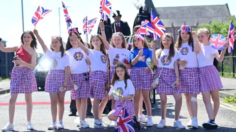 Pacemaker Girls waving flags on Shankill Road