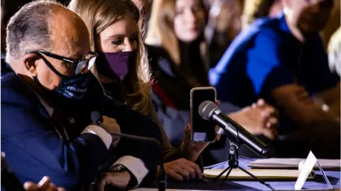 Getty Images Rudolph Giuliani, shown in Pennsylvania with lawyer Jenna Ellis, leads the president's effort to challenge the election