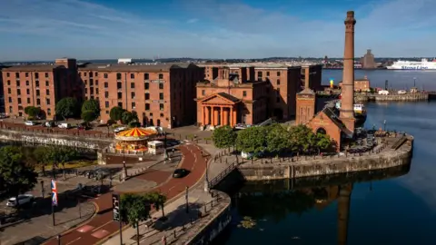 Liverpool Albert Dock buildings, showing the slavery and maritime museum, with the River Mersey in the background