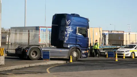 Padraig OReilly / SplashNews.com Armed Irish police stop the lorry cab