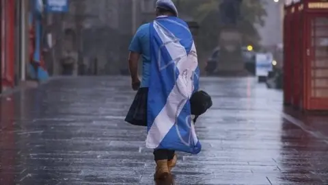 PA Media Scottish independence supporter walking along Edinburgh's Royal Mile after 2014 vote